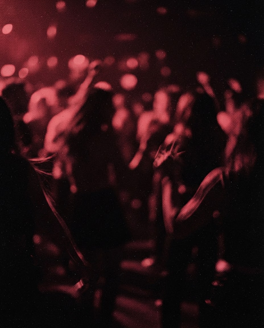 The floor packed, smeared by the red light